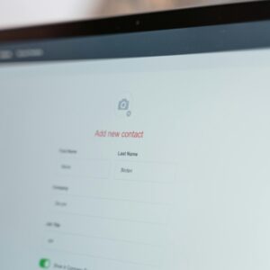 Close-up of a computer screen with an open contact form for adding a new entry.